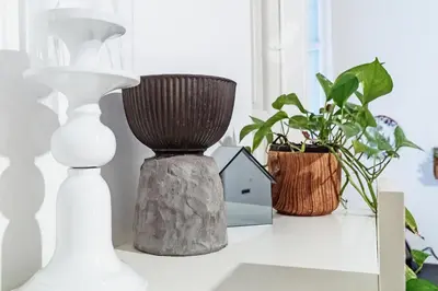a table with vases and plants on it at Loft35 - Loft con Vasca Idromassaggio nel Cuore di Palermo 
