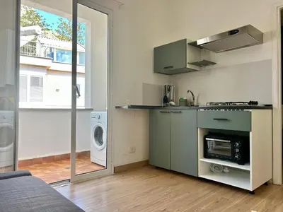 a kitchen with a stove and a washer and dryer at Charlotte in Palermo
