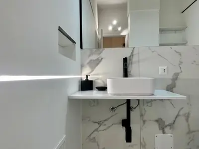 a white bathroom with a sink on a shelf at Charlotte in Palermo