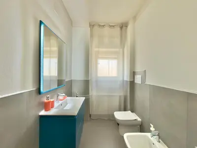 a bathroom with a white toilet and a sink at Cantieri 58 in Palermo