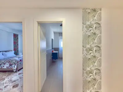 a view of a room with a bed and a hallway at Cantieri 58 in Palermo