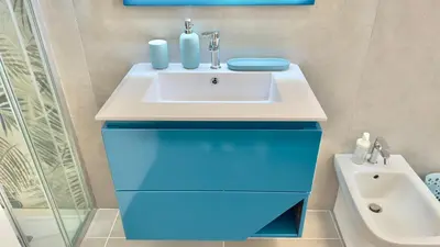 a bathroom with a white sink and blue drawers at Cantieri 58 in Palermo