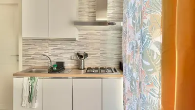 a small kitchen with a sink and a stove at Cantieri 58 in Palermo