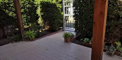 a patio with potted plants and a gate at Casa a Campofelice di Roccella in Campofelice di Roccella