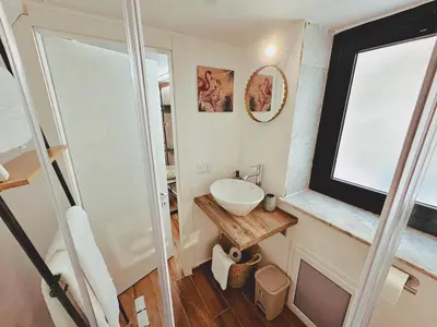a small bathroom with a sink and a mirror at Oxalis Rooms & Suite in Palermo