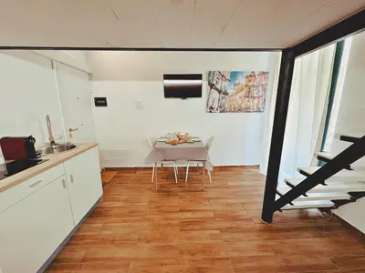 a kitchen with a table in the middle of a room at Oxalis Rooms & Suite in Palermo