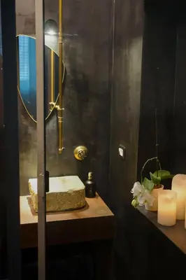 a bathroom with a sink with a mirror and candles at Serafina Suites in Palermo