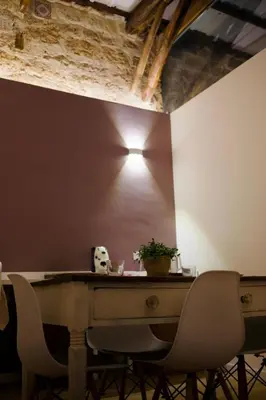 a bedroom with a large white bed and a table at Serafina Suites in Palermo