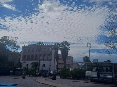 a cloudy sky over a city with a bus at Art suite palermo in Palermo