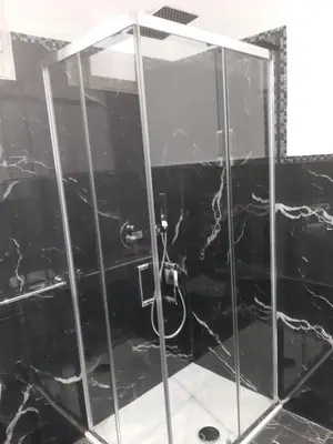 a shower with a glass door in a bathroom at Suite Nobile in Palermo