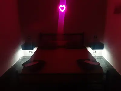 a bedroom with a bed with a pink light on it at Suite Nobile in Palermo
