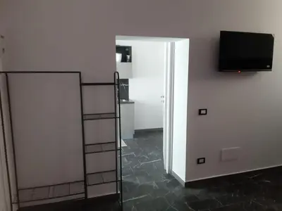 a living room with a television and a ladder at Suite Nobile in Palermo