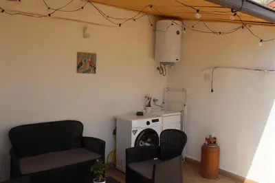 a living room with two chairs and a stove at 30House in Palermo