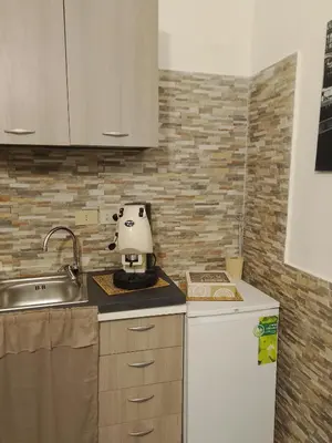 a kitchen with a mixer on a counter next to a sink at La casetta di Barbara in Palermo