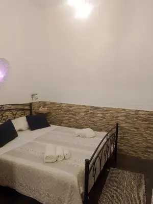 a bedroom with a bed with two towels on it at La casetta di Barbara in Palermo