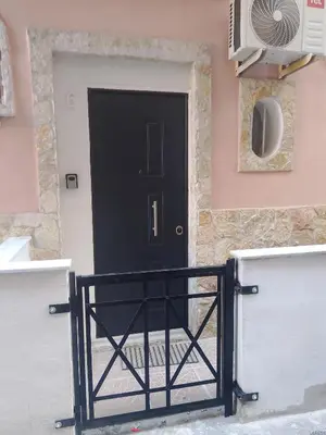 a black door in front of a building at La casetta di Barbara in Palermo