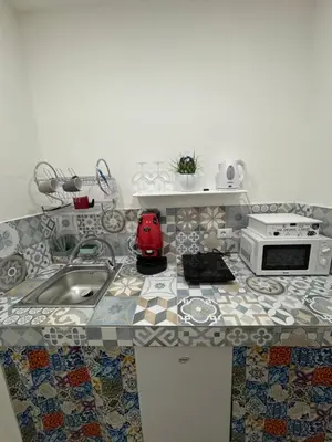 a kitchen counter with a sink and a microwave at Cristofarohome2 in Palermo
