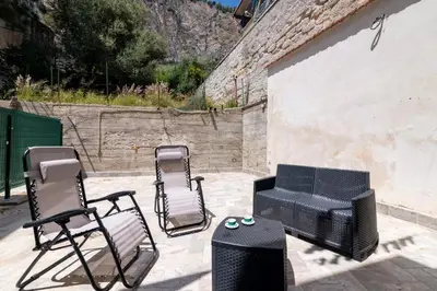 a group of chairs and a grill and a television at GuestHost - Seaview Apartments near Palermo in Palermo