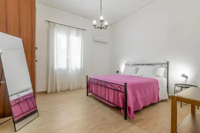 a bedroom with a bed with a pink blanket at GuestHost - Seaview Apartments near Palermo in Palermo