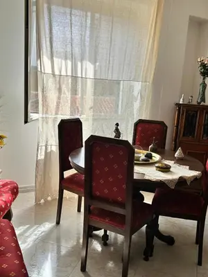 a dining room with a table and chairs and a window at Casa Mirella in Aspra