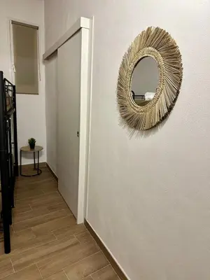 a hallway with a mirror on the wall and a door at Casa di Anna in Palermo