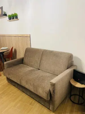 a brown couch in a living room with tables at Casa di Anna in Palermo