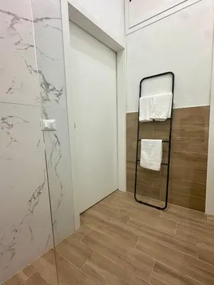 a bathroom with a towel rack and a glass door at Casa di Anna in Palermo