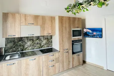 a kitchen with wooden cabinets and a sink at Casa di Anna in Palermo