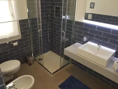 a bathroom with a toilet and a sink and a shower at B&B Cala Peppa in Palermo