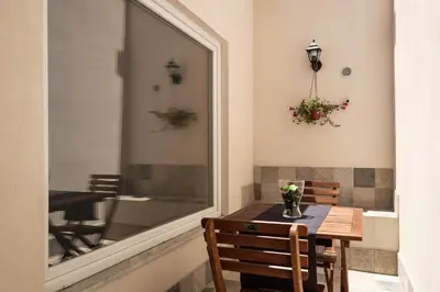 a table and chairs in a room with a window at B&B Cala Peppa in Palermo