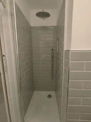 a bathroom with a shower with a glass door at B&B Cala Peppa in Palermo