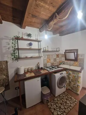 a kitchen with a stove and a washing machine at Al vicolo holiday home in Palermo