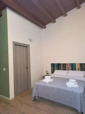 a bedroom with a bed with towels on it at La Casetta di Lilla in Palermo