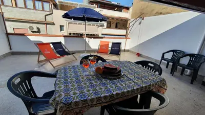 a table with a hat on top of a balcony at Casa Nonna Rosa in Balestrate