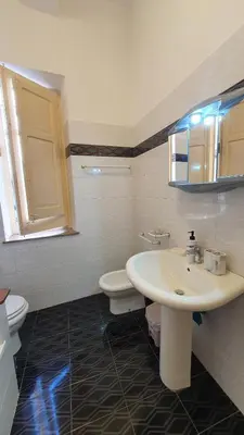 a bathroom with a sink and a toilet at Casa Nonna Rosa in Balestrate