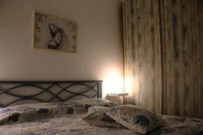 a bedroom with a bed and a picture on the wall at Summer House in Buonfornello