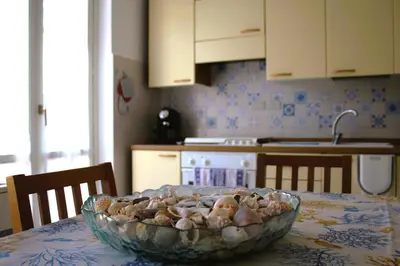 a bowl of mushrooms on a table in a kitchen at Summer House in Buonfornello