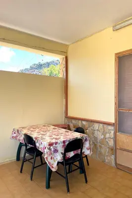 a table and chairs in a room with a window at Appartamento vicino Palermo - 2 bedr in Trabia in Trabia