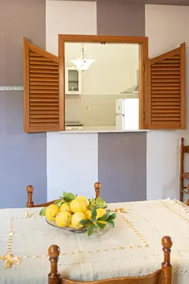 a bowl of lemons on a table in a kitchen at Appartamento vicino Palermo - 2 bedr in Trabia in Trabia