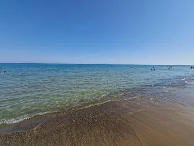 a group of people in the water at the beach at Silville in Campofelice di Roccella