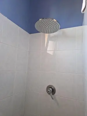 a shower with a shower head in a bathroom at Silville in Campofelice di Roccella