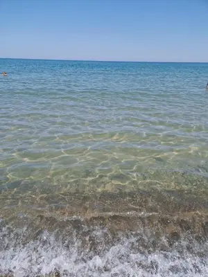 a large body of water with rocks in it at Silville in Campofelice di Roccella