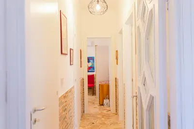 a hallway in a home with white walls and tile floors at villa ulivo rovetto in Mandra Capreria