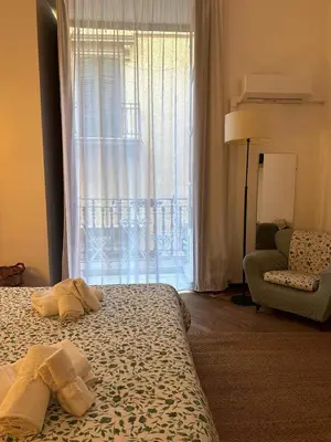 a hotel room with a bed and a window at La finestra sugli archi in Palermo
