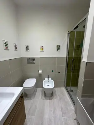 a bathroom with a toilet and a sink and a shower at La finestra sugli archi in Palermo