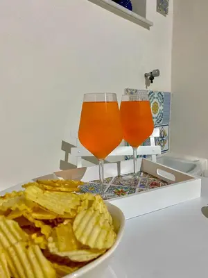 two glasses of beer and a bowl of crisps and chips at Casimiro in Porticello