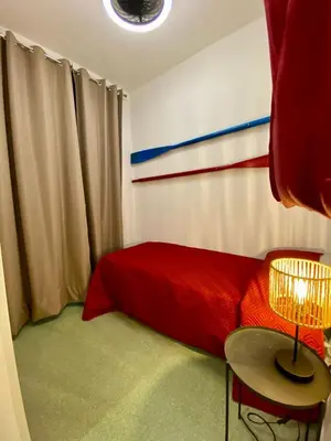 a bedroom with a red bed and a table at Casimiro in Porticello