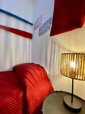 a bedroom with a bed and a lamp on a table at Casimiro in Porticello