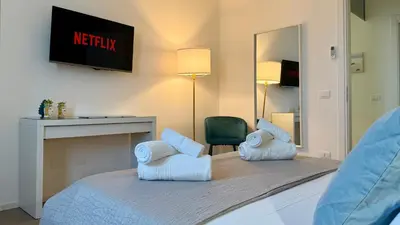 a bedroom with a bed with towels on it at Castellammare Residence in Palermo