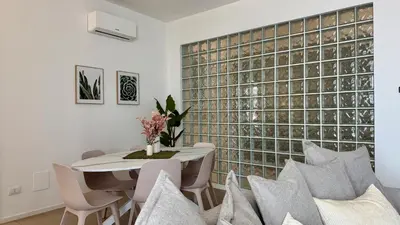a room with two beds and a door to a bedroom at Castellammare Residence in Palermo